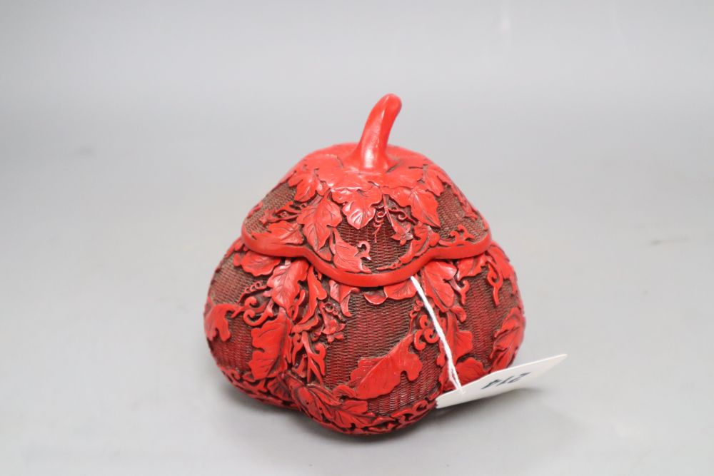 A Chinese cinnabar style box in the form of a fruit, height 12cm